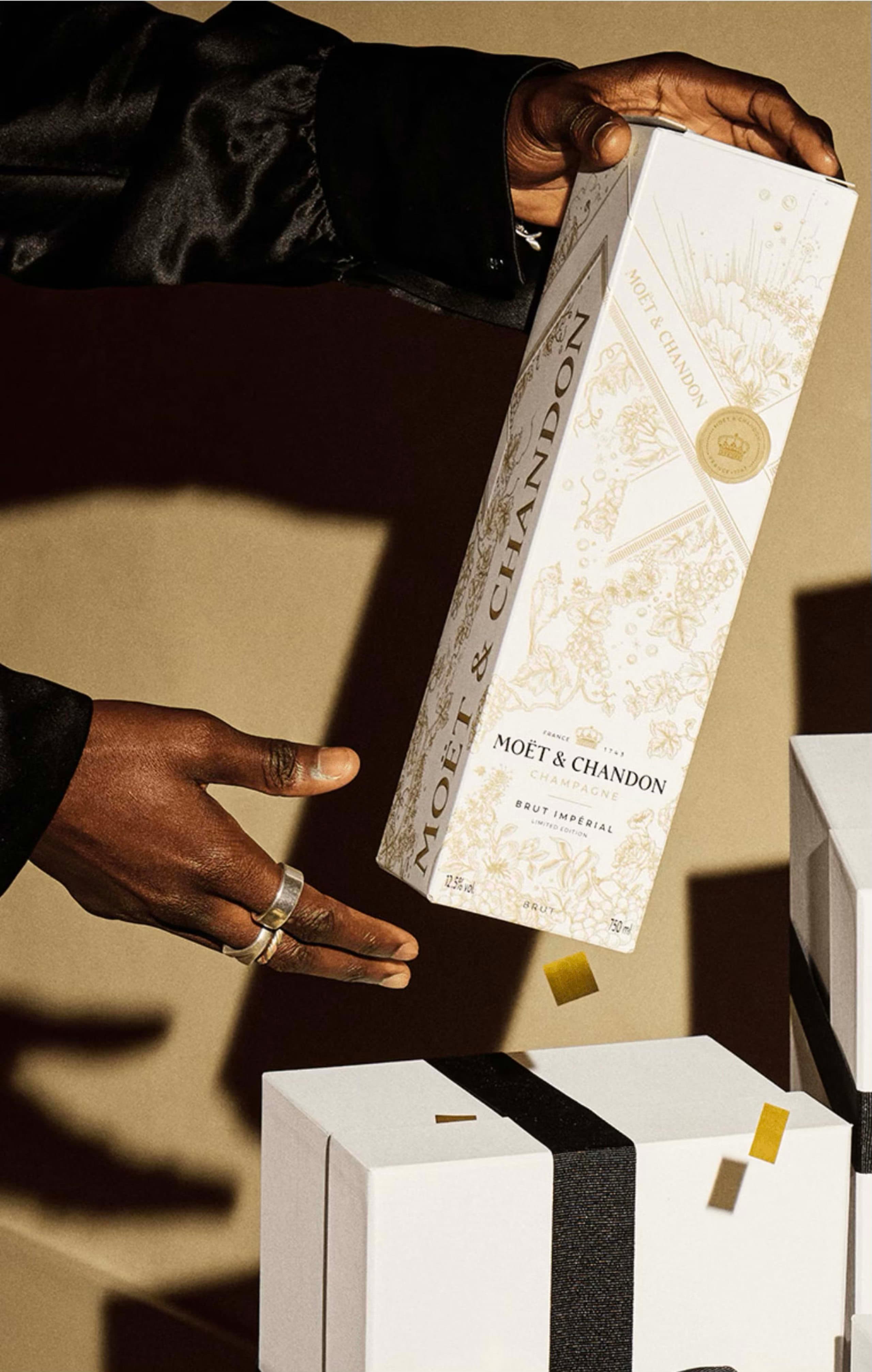 hand presenting a Moët & Chandon illustrated gift box