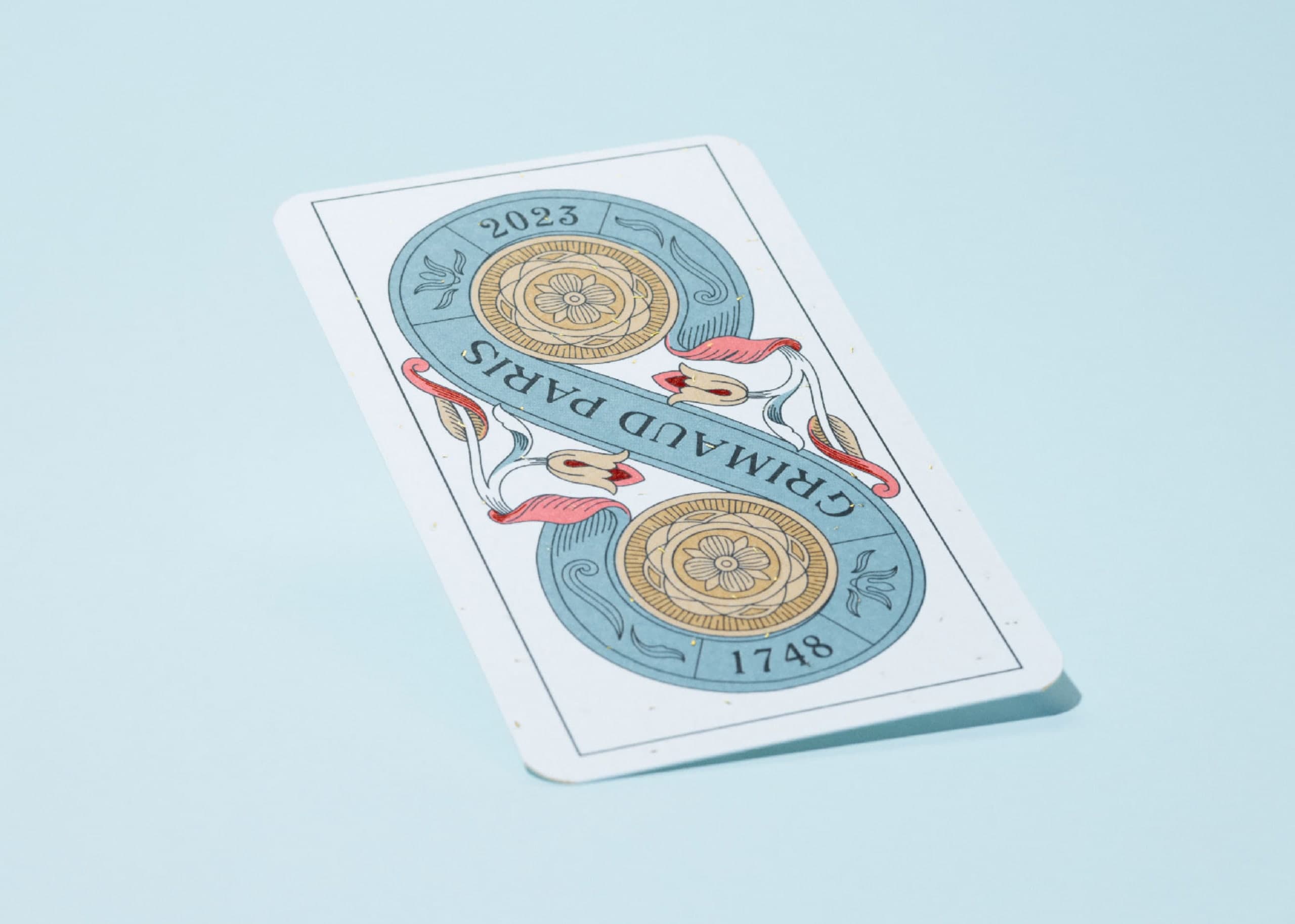 Two of Coins from the Tarot de Marseille N°400 by Swindler & Swindler for Grimaud Paris — hand-drawn fine line engraving style, eight Pantone colours and a gold foil pass.